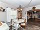 Bright dining room with a modern chandelier and direct access to the living room at 22 Walnut Nw Ave # 1, Concord, NC 28027