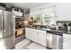 Functional kitchen featuring a stainless steel refrigerator, double sink, and ample counter space at 22 Walnut Nw Ave # 1, Concord, NC 28027