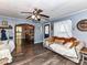 Cozy living room with hardwood floors, a ceiling fan, and ample natural light at 22 Walnut Nw Ave # 1, Concord, NC 28027