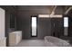 Contemporary bathroom showcasing a freestanding tub, tiled walls, and a narrow window at 22554 John Gamble Rd, Cornelius, NC 28031