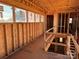 Upstairs hallway featuring wood framework, large windows, and natural light at 22554 John Gamble Rd, Cornelius, NC 28031