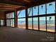 Spacious living area in new construction with large windows overlooking lake and natural light at 22554 John Gamble Rd, Cornelius, NC 28031