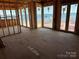 Spacious unfinished main bedroom suite with large windows offering beautiful water views at 22554 John Gamble Rd, Cornelius, NC 28031