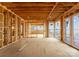Unfinished primary bedroom with large windows overlooking the water at 22554 John Gamble Rd, Cornelius, NC 28031
