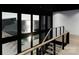 Modern staircase with views of the lake, pool and patio, offering a blend of indoor-outdoor living at 22554 John Gamble Rd, Cornelius, NC 28031