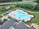 Aerial view of community pool with ample seating, a kid-friendly beach entry, and mature landscaping at 2364 Delaney Dr, Fort Mill, SC 29715