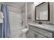 Bathroom featuring granite counters, framed mirror, and a tub and shower combination at 2364 Delaney Dr, Fort Mill, SC 29715