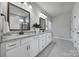 Bathroom featuring double sinks, granite countertops, and a tiled shower at 2364 Delaney Dr, Fort Mill, SC 29715