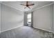 Bright bedroom features a ceiling fan and natural light from a window with decorative curtains at 2364 Delaney Dr, Fort Mill, SC 29715