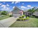 Inviting single-story home with well-maintained landscaping, two-car garage, and a charming entryway at 2364 Delaney Dr, Fort Mill, SC 29715