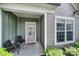 Welcoming entryway with covered porch, seating, and sidelight windows, offering both style and curb appeal at 2364 Delaney Dr, Fort Mill, SC 29715