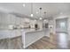 Bright kitchen features white cabinetry, granite counters, stainless steel appliances, and a spacious center island at 2364 Delaney Dr, Fort Mill, SC 29715