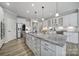 Bright kitchen with a large island, granite countertops, stainless steel appliances, and modern pendant lighting at 2364 Delaney Dr, Fort Mill, SC 29715