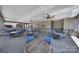 Enclosed outdoor seating area featuring tables, chairs, ceiling fans, and stone accents at 2364 Delaney Dr, Fort Mill, SC 29715