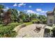 Beautiful outdoor patio with built-in grill, mature trees, and landscaped backyard at 2364 Delaney Dr, Fort Mill, SC 29715
