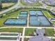 Aerial view showcases tennis and pickleball courts, bocce ball, and the neighborhood layout at 2364 Delaney Dr, Fort Mill, SC 29715