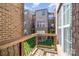 Balcony overlooking courtyard with brick exteriors at 243 Lincoln St, Charlotte, NC 28203