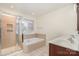 Bathroom showcasing a tiled walk-in shower, soaking tub, and double sink vanity at 243 Lincoln St, Charlotte, NC 28203
