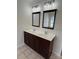 Bathroom featuring double sink vanity with dark wood cabinets at 243 Lincoln St, Charlotte, NC 28203