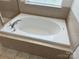 Close-up of a bathtub with tile surround at 243 Lincoln St, Charlotte, NC 28203