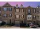Charming townhome with a brick facade, a well-maintained landscape and attached garages at 243 Lincoln St, Charlotte, NC 28203