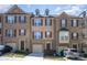 Charming brick townhome featuring a two car garage and classic shuttered windows, perfect for modern living at 243 Lincoln St, Charlotte, NC 28203