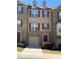 Attractive brick townhome with an attached garage, dormer windows, and well-maintained landscaping at 243 Lincoln St, Charlotte, NC 28203