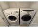 Convenient laundry room featuring a washer and dryer, with shelving for storage at 243 Lincoln St, Charlotte, NC 28203