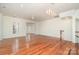 Open-concept living area with hardwood floors, neutral walls, recessed lighting, and staircase access at 243 Lincoln St, Charlotte, NC 28203