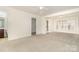 Bright, spacious living room with carpet, natural light, and neutral tones, perfect for versatile decorating at 243 Lincoln St, Charlotte, NC 28203