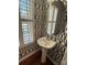 Half bath with pedestal sink and patterned wallpaper at 243 Lincoln St, Charlotte, NC 28203