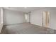 Spacious bedroom with neutral carpet and multiple access doors at 2605 Goose Fair Rd, Maiden, NC 28650