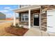 Welcoming front entrance with stone accents, white columns, and a stylish black front door at 2605 Goose Fair Rd, Maiden, NC 28650