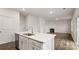 Kitchen island with seating, stainless steel dishwasher and open layout to living area at 2605 Goose Fair Rd, Maiden, NC 28650