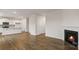 Open-concept living room and kitchen area with hardwood floors and a cozy fireplace at 2605 Goose Fair Rd, Maiden, NC 28650