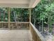 View of a wooden back porch with railings overlooking a lush forest at 2924 Noritake Trl # 67, Albemarle, NC 28001