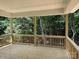 New wooden back porch with railings overlooking a dense forest at 2924 Noritake Trl # 67, Albemarle, NC 28001