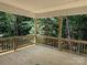 Wooden back porch with railings overlooking a dense forest view at 2924 Noritake Trl # 67, Albemarle, NC 28001