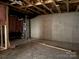 Unfinished basement with concrete wall, exposed ductwork, and wood framing at 2924 Noritake Trl # 67, Albemarle, NC 28001