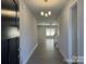 Welcoming entryway featuring wood-look floors, modern chandelier, and neutral paint throughout the home at 2924 Noritake Trl # 67, Albemarle, NC 28001