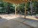 A concrete patio with wooden support beams that look into the woods at 2924 Noritake Trl # 67, Albemarle, NC 28001