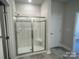 Modern walk-in shower featuring white subway tile and a glass door in this updated bathroom at 2924 Noritake Trl # 67, Albemarle, NC 28001