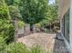 Charming brick patio surrounded by lush greenery, creating a private outdoor retreat at 3066 Orion Dr, Fort Mill, SC 29707