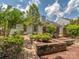 Landscaped backyard with a brick pathway, raised flower beds, and mature trees at 3066 Orion Dr, Fort Mill, SC 29707
