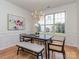 Bright dining room with a modern table, stylish seating, and large windows overlooking the backyard at 3066 Orion Dr, Fort Mill, SC 29707