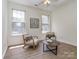 Cozy living room with hardwood floors, large windows, and comfortable chairs at 3066 Orion Dr, Fort Mill, SC 29707