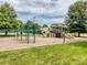 This playground offers various climbing structures and slides, surrounded by mulch and green grass at 3066 Orion Dr, Fort Mill, SC 29707