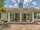 Exterior view of a sunroom with glass doors leading to a brick patio and landscaped yard at 3066 Orion Dr, Fort Mill, SC 29707