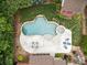 Aerial view of a backyard oasis, featuring a freeform pool, spa, and lounging area, surrounded by lush landscaping at 310 E Waterlynn Rd, Mooresville, NC 28115