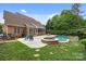 Beautiful backyard including an in-ground pool, spa, patio, lush landscaping, and manicured lawn at 310 E Waterlynn Rd, Mooresville, NC 28115